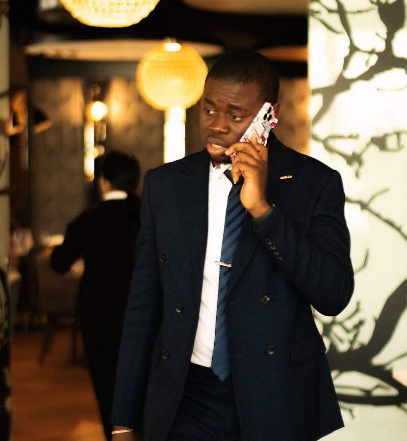 Man in suit talking on phone in restaurant