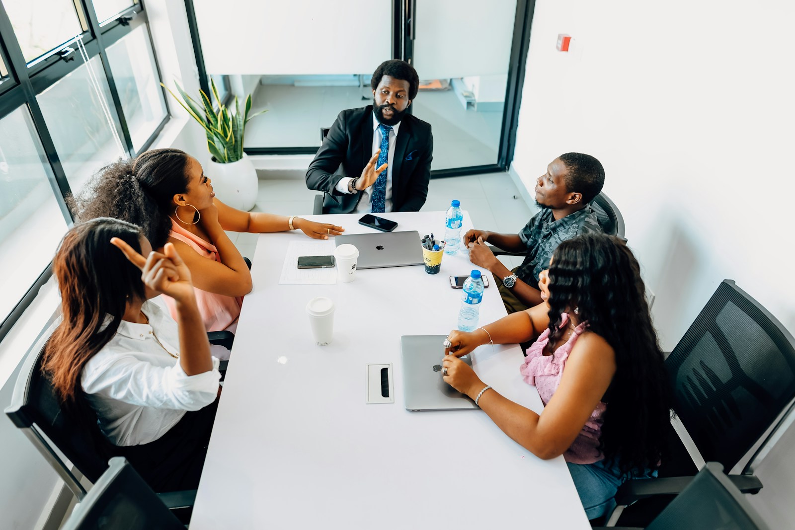 A group of people sitting around a white table